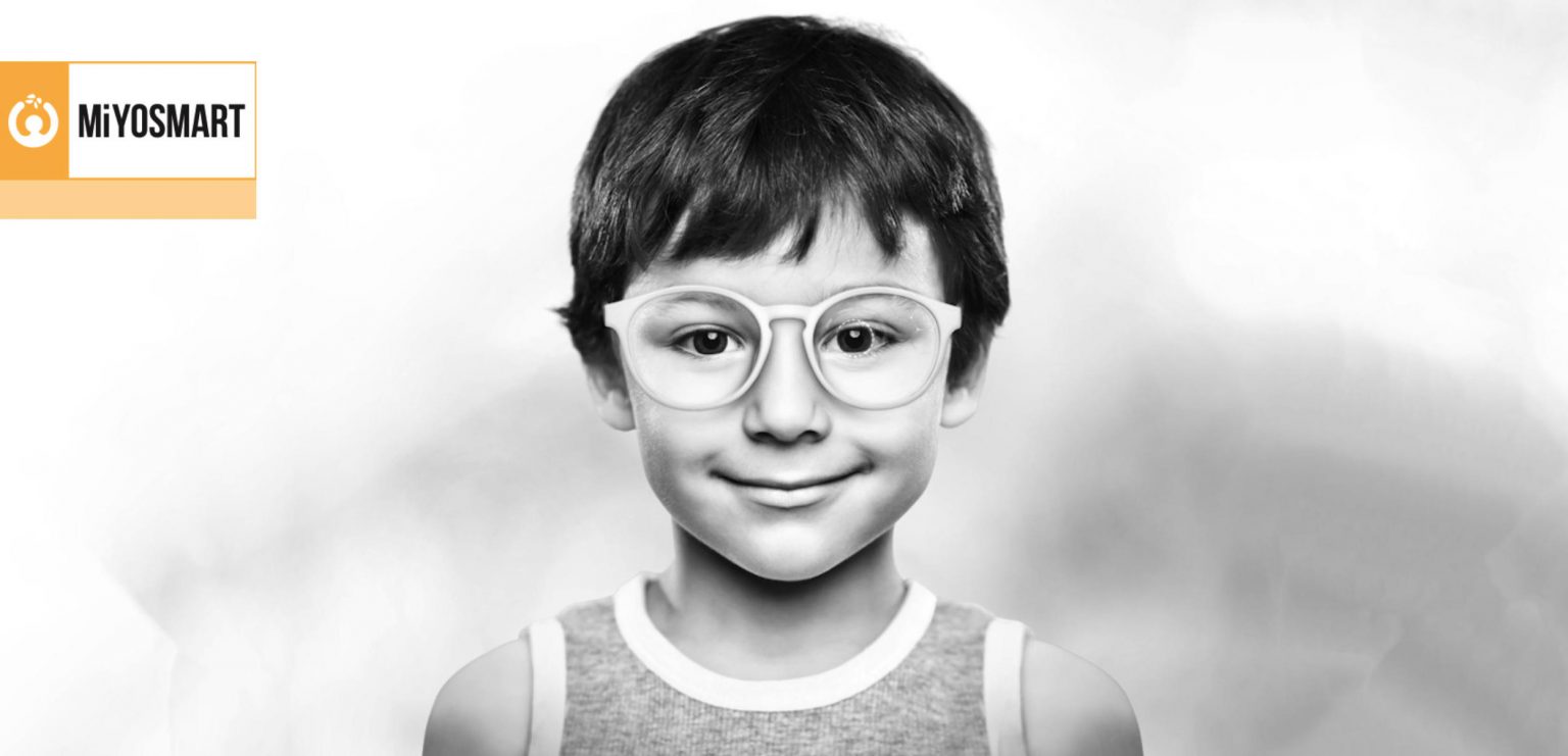Little boy smiling wearing glasses with the Hoya MiyoSmart lenses